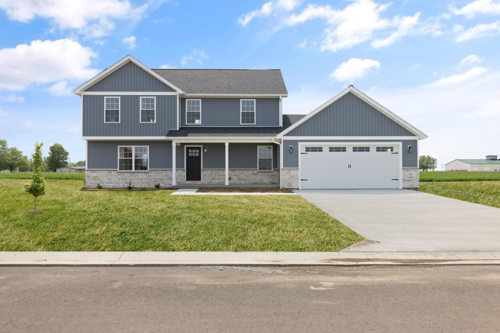 Two-story gray house with a two-car garage and a front lawn