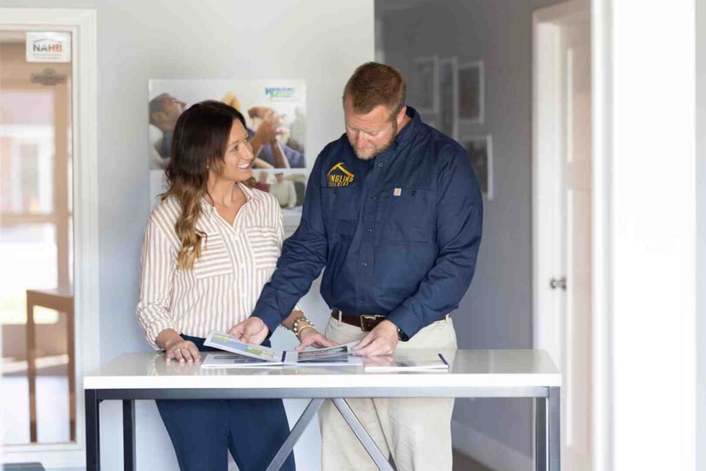 Woman and man reviewing brochures at a table in an office