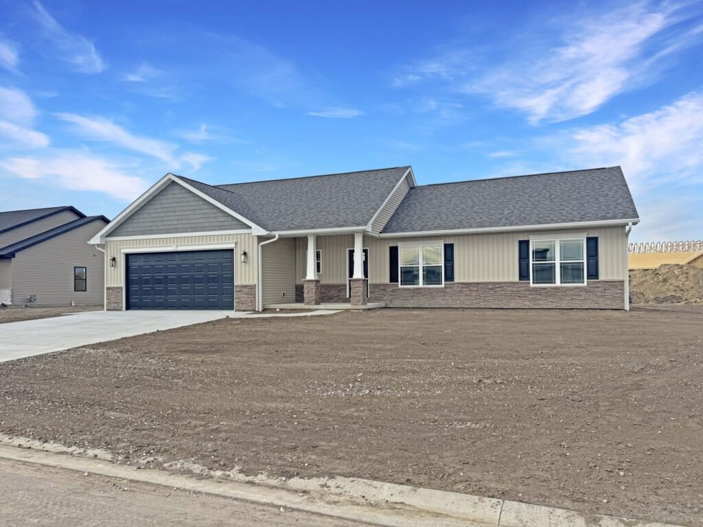 New single-story house with a two-car garage and unfinished front yard