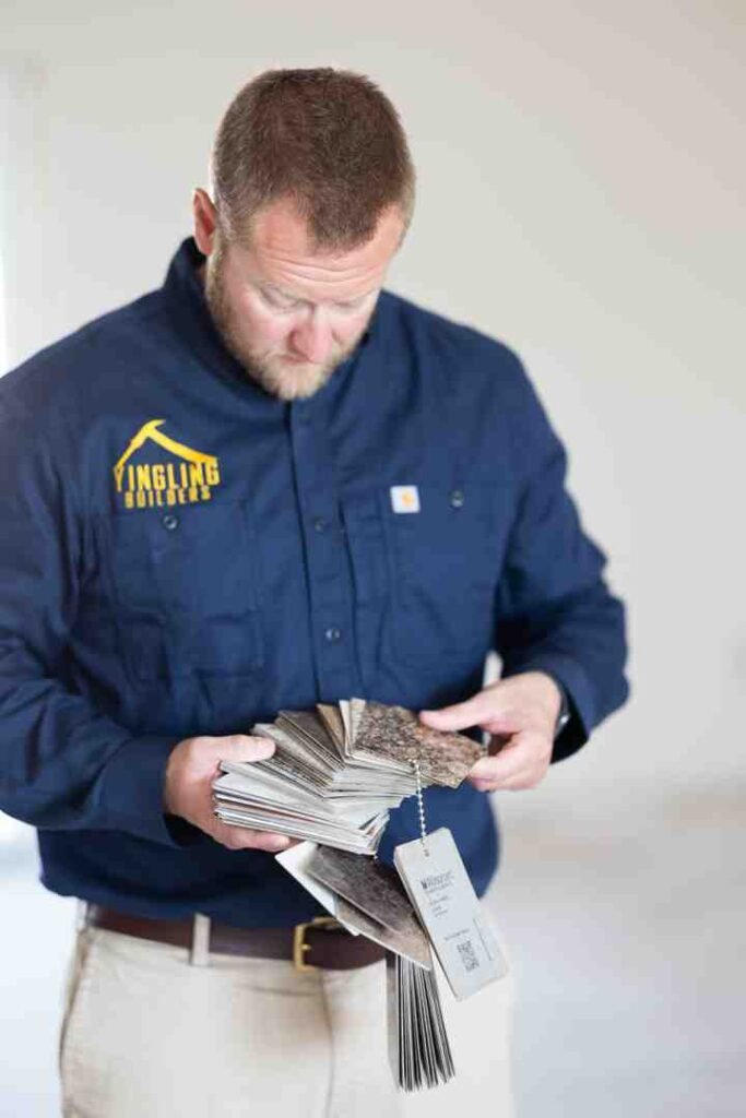 Man holding a stack of paint color sample cards